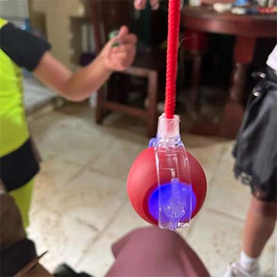 red smart toy for pets being suspended in the air by happy customer